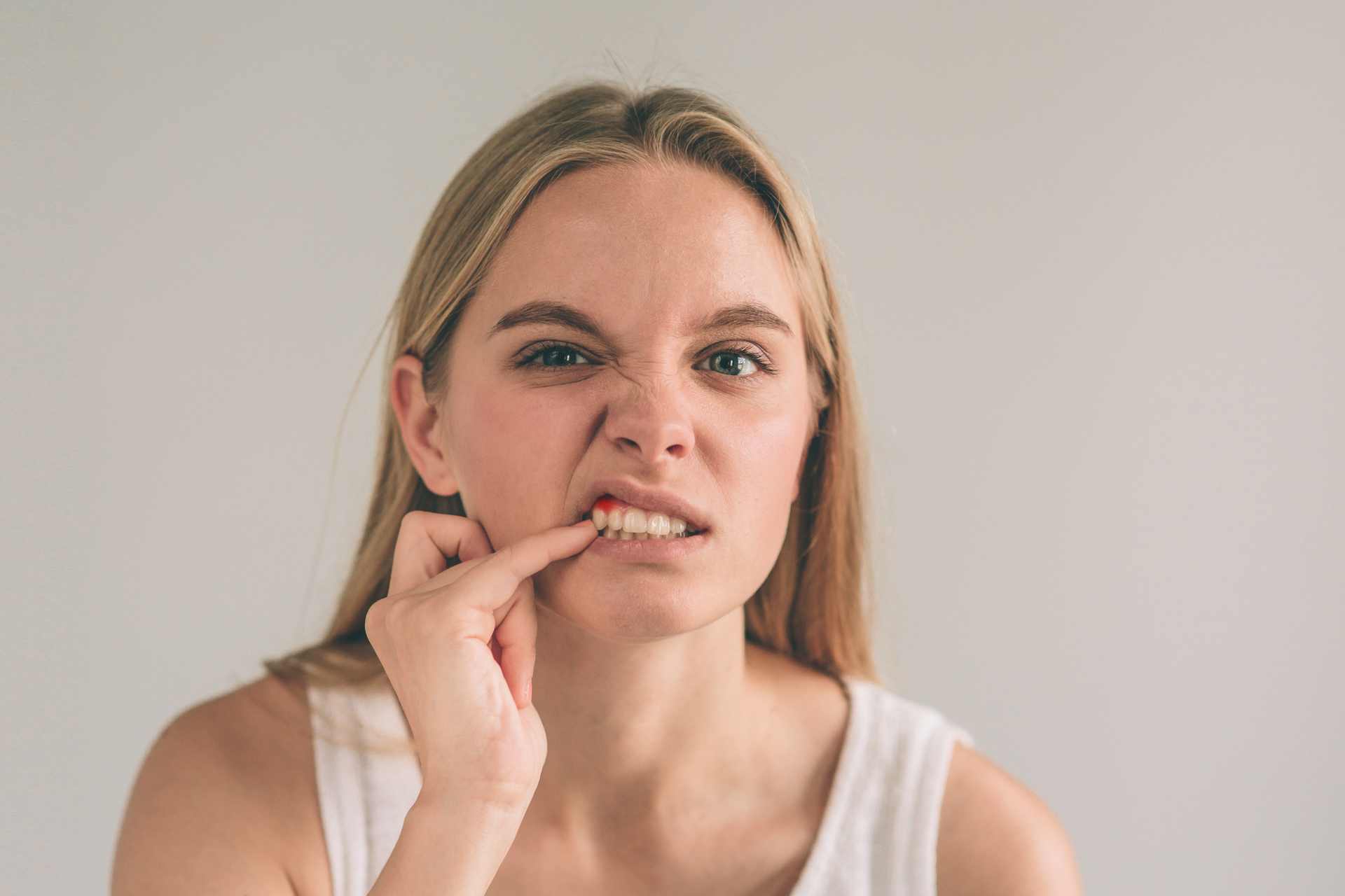 01 A young woman concerned about whether she has receding gums on a single tooth