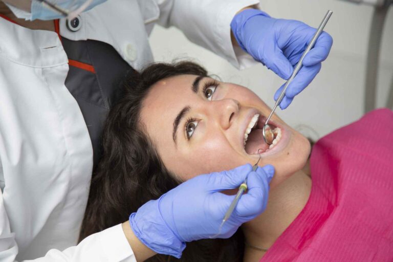 14 Closeup of a dentist performing an oral checkup on a girl