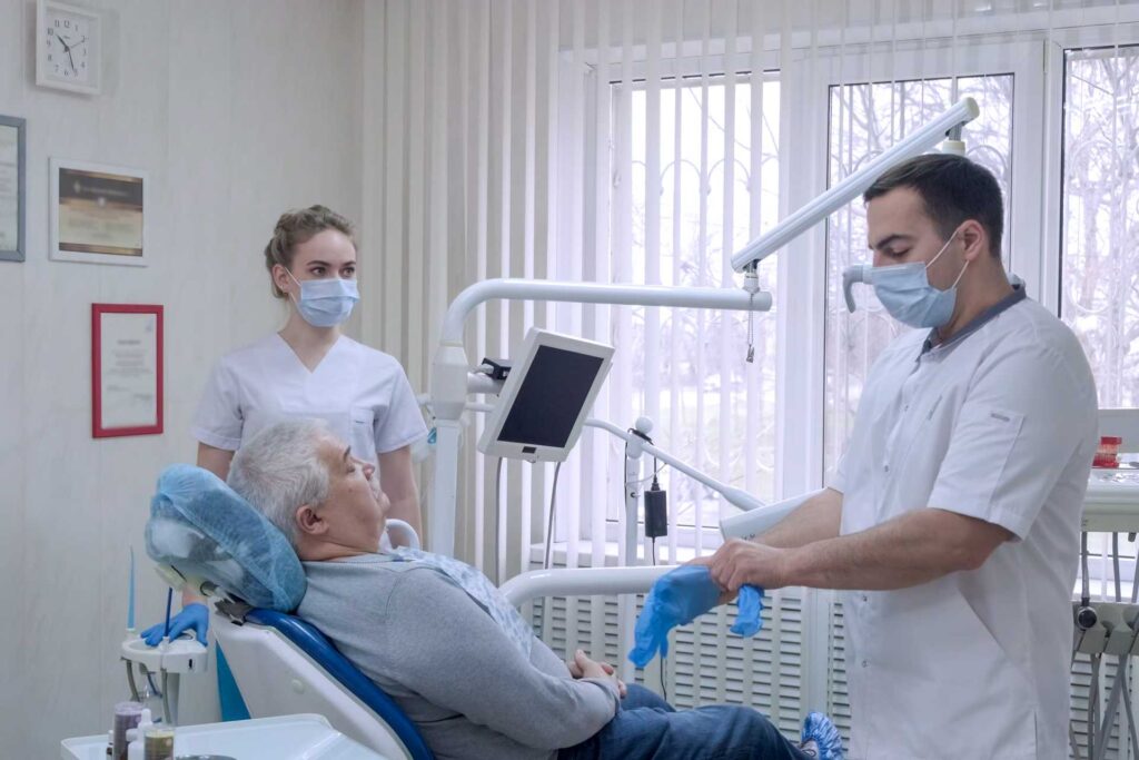 09 A dentist and his assistant performing a treatment to a patient_Dental implants procedure, dental implants in Miami