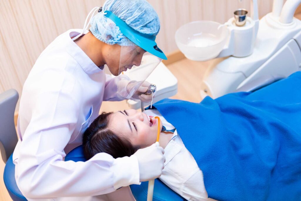 10 A dentist performing a procedure on a patient at the clinic_Recovery of dental implants, Dental Implants in Miami