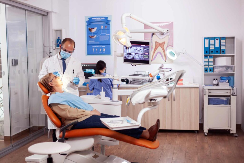 14 Senior woman receiving treatment at a dental clinic_U.S. dental insurance covering implants