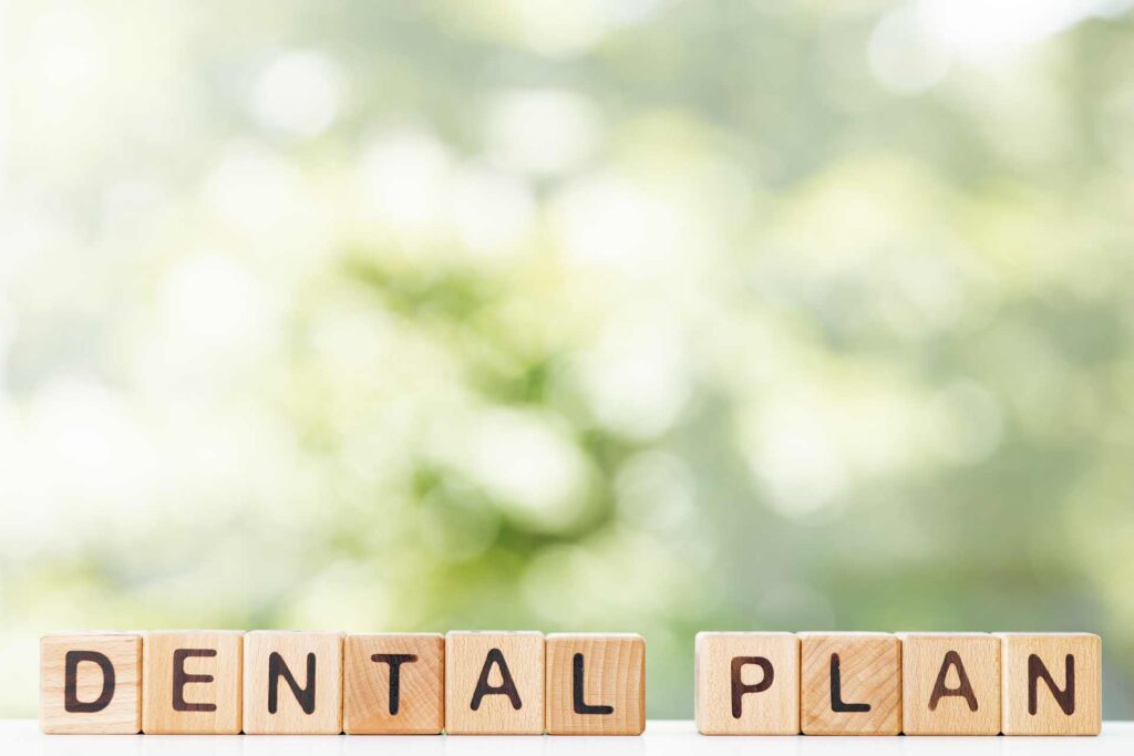 15 The phrase 'dental plan' written in wooden letters_U.S. dental insurance covering implants