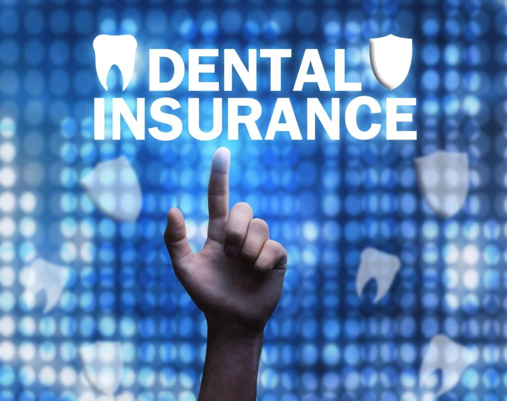 18 Male hand pointing to a 'dental insurance' sign _Dental insurance in the U.S. covering implants